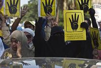  Morsi supporters display the four-finger symbol 
